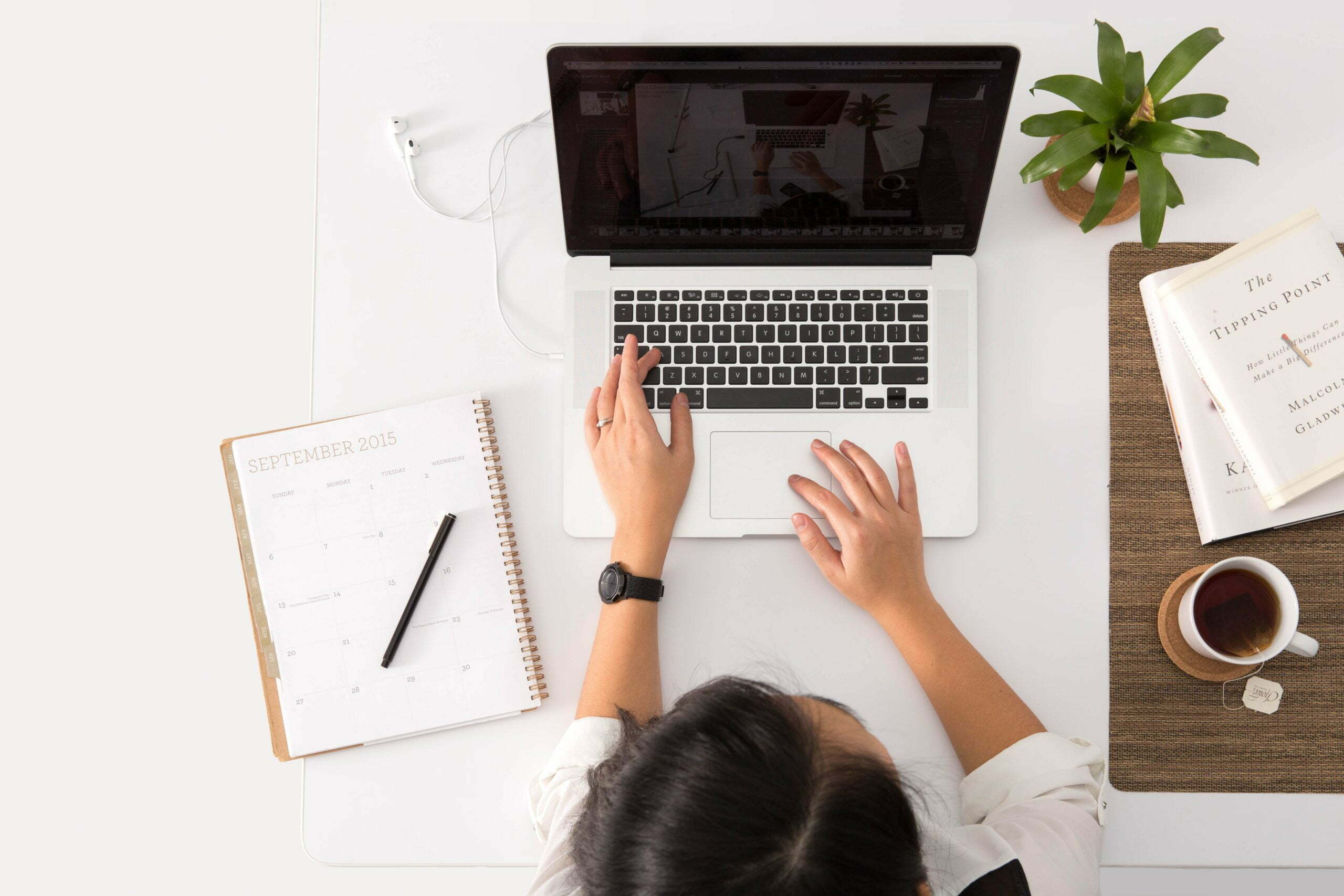 person working online on laptop and notebook